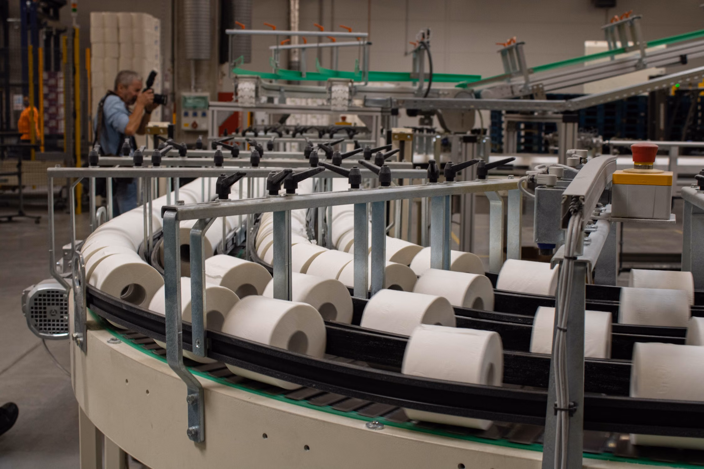 Finished toilet paper rolls moving along an industrial converting line