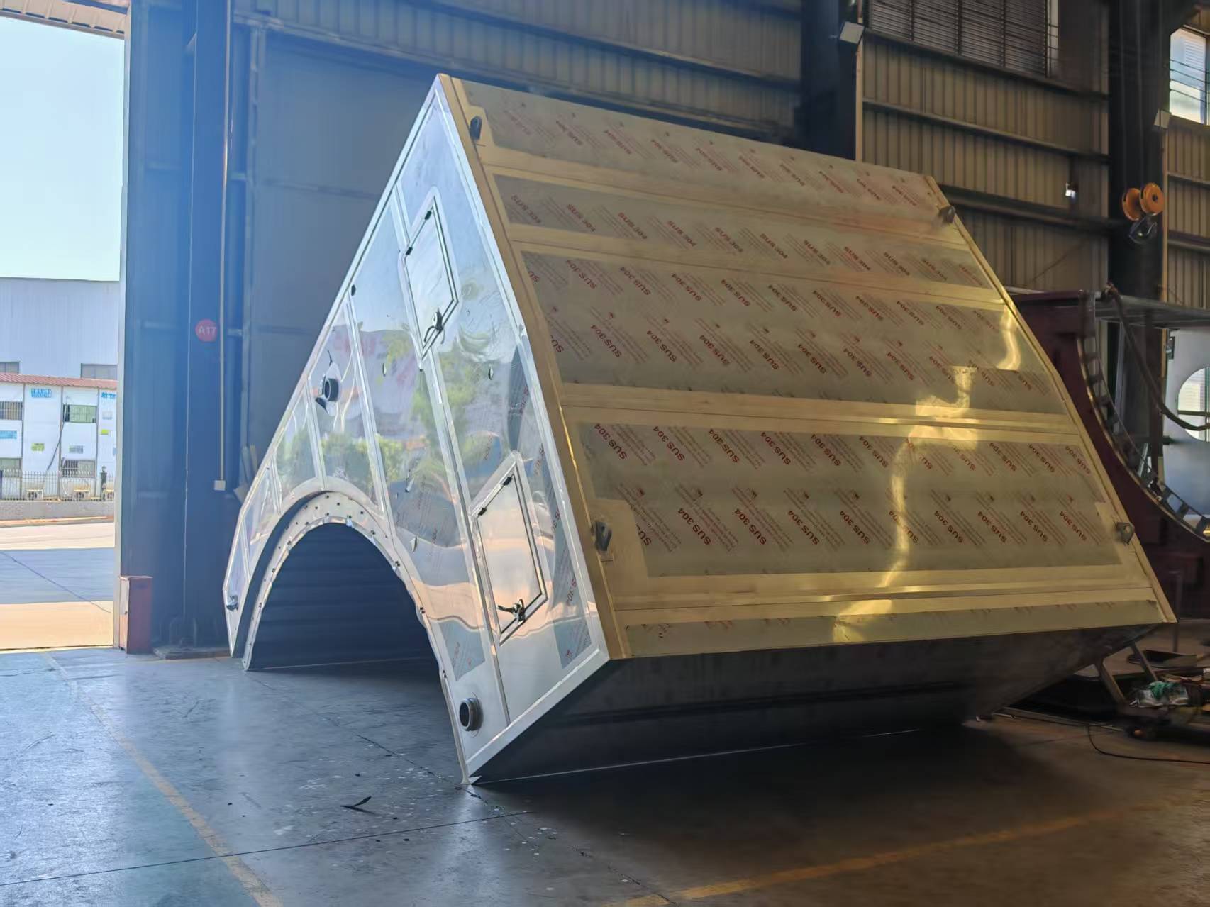 Yankee drying hood section with curved opening and access doors in the workshop